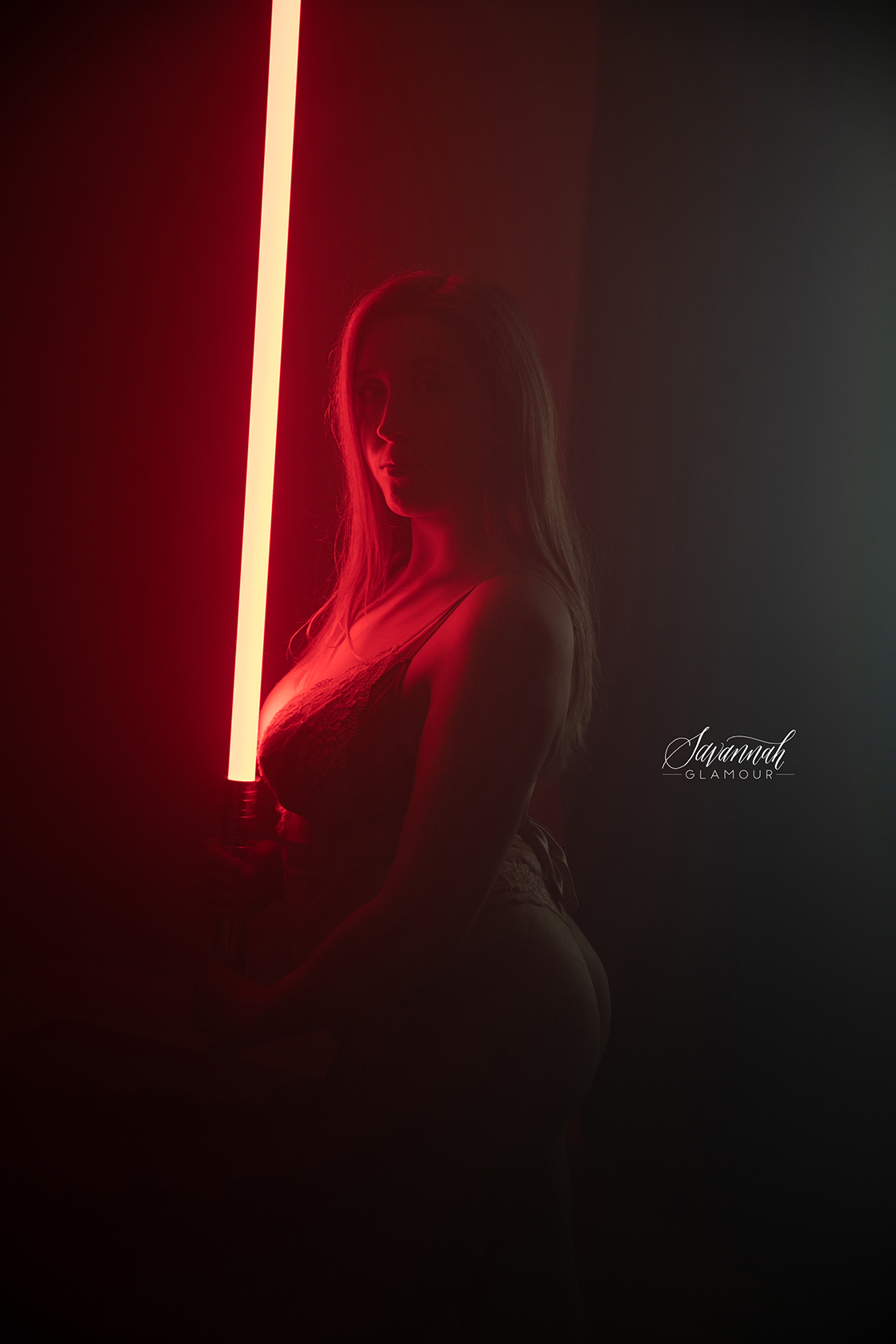 woman in lingerie holding a lightsaber