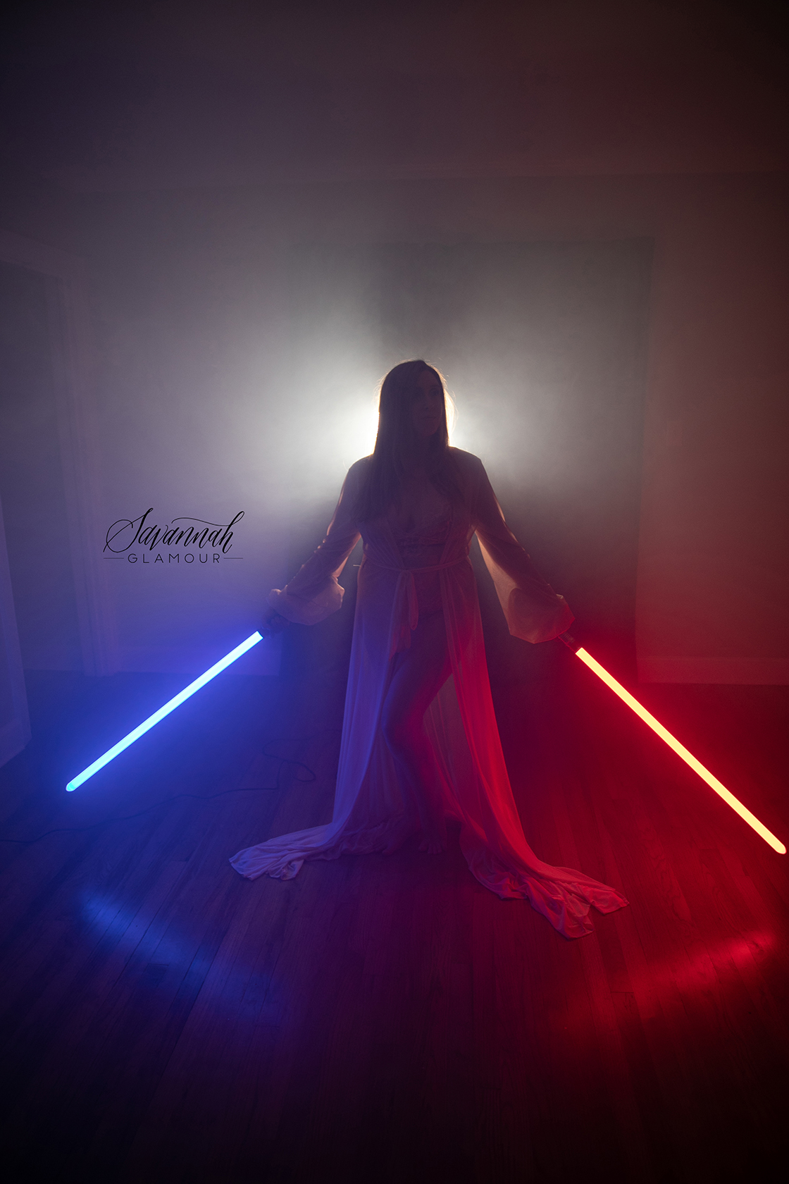 silhouette of a woman holding two lightsabers