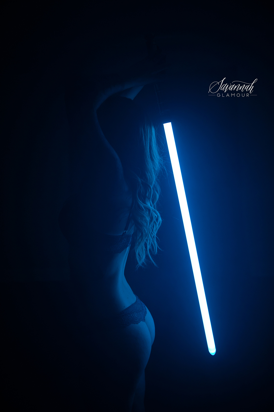 lightsaber illuminating woman's back wearing lingerie