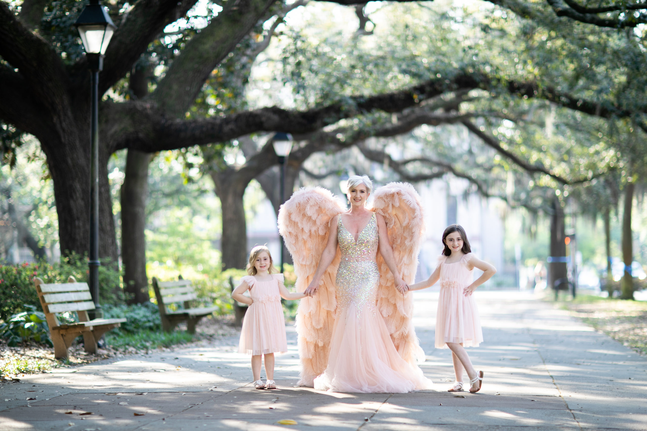 mother and 2 daughters posing for glamour portrait in pink gowns