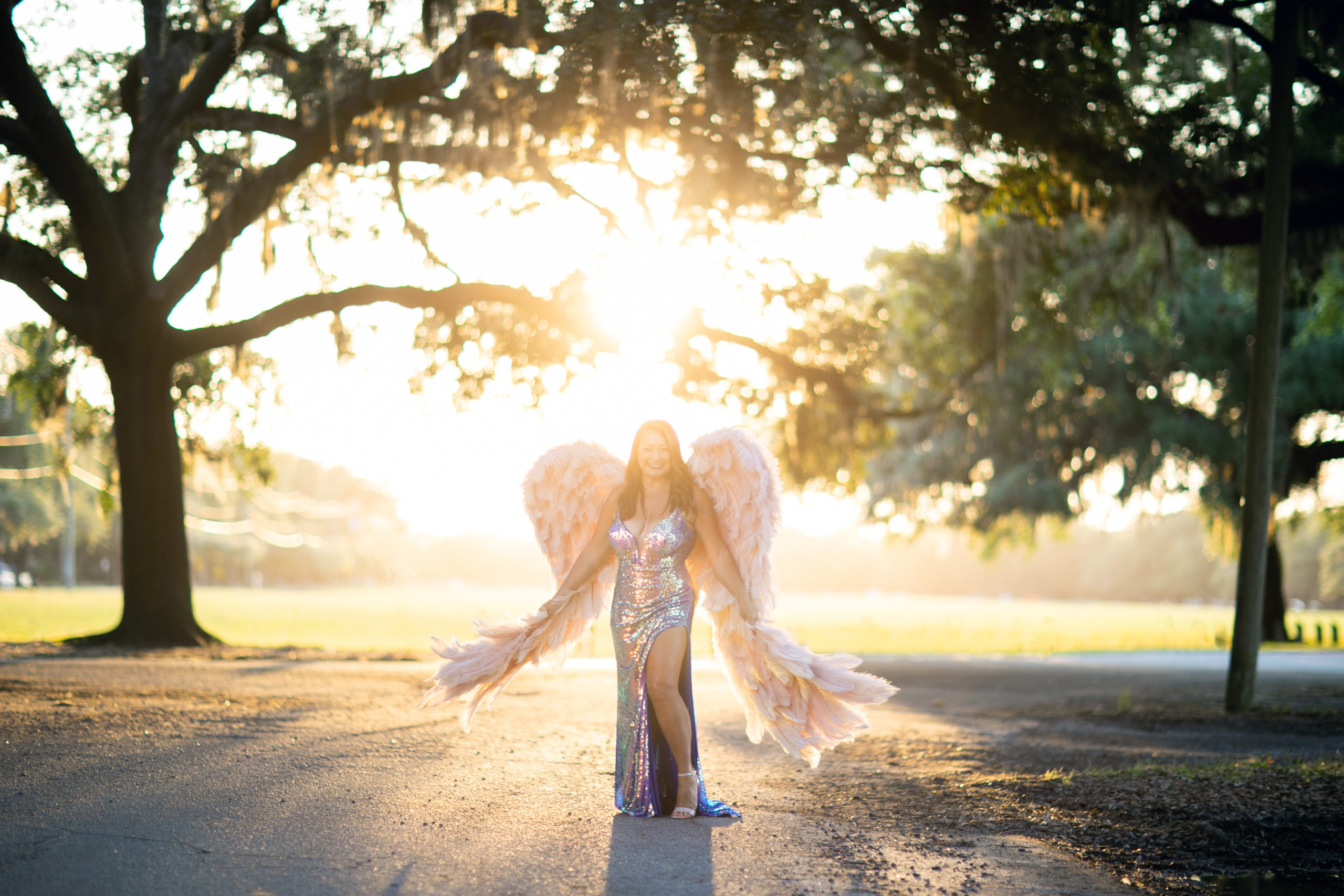 outdoor portrait of woman wearing gown and angel wings
