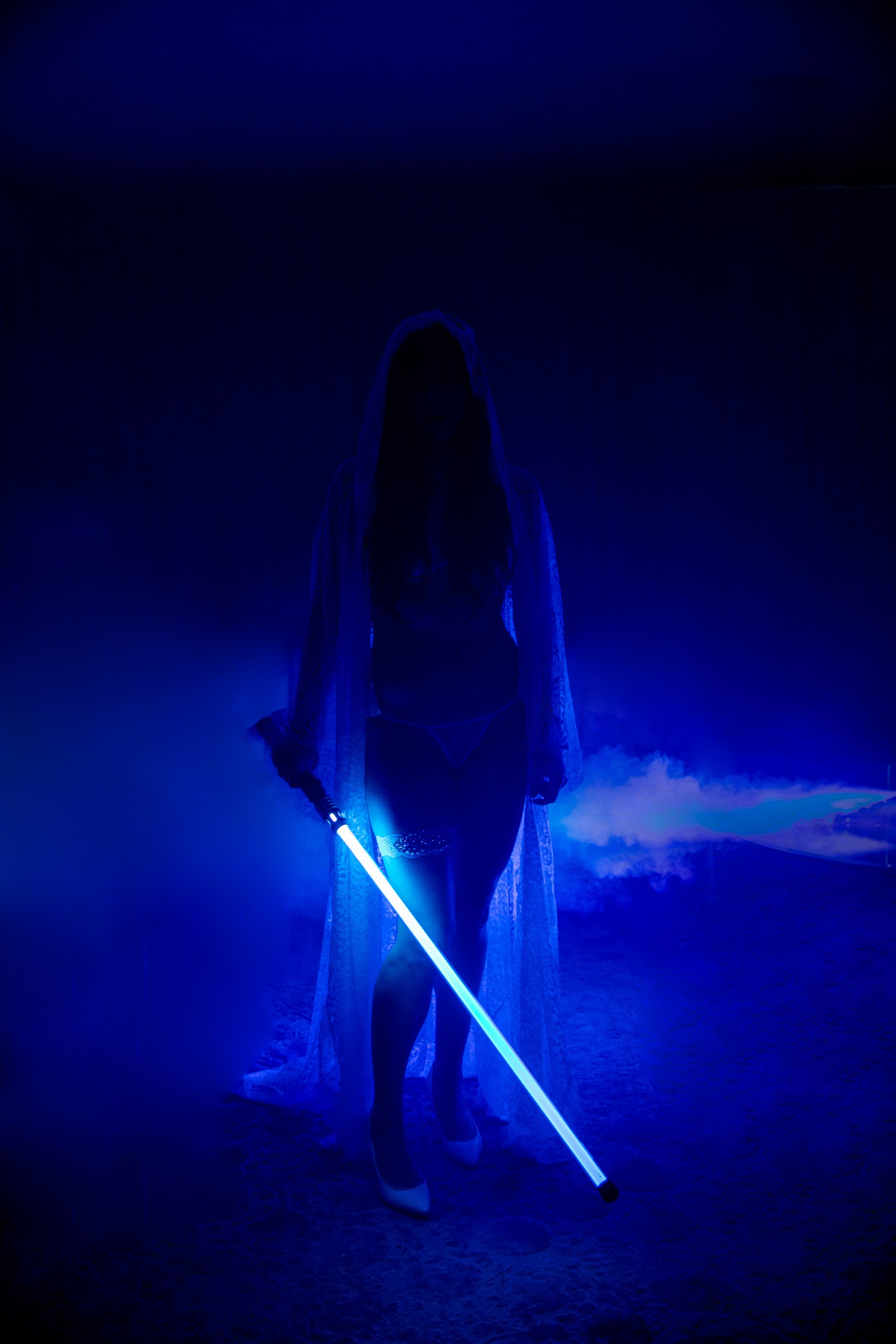 woman's silhouette illuminated by light saber