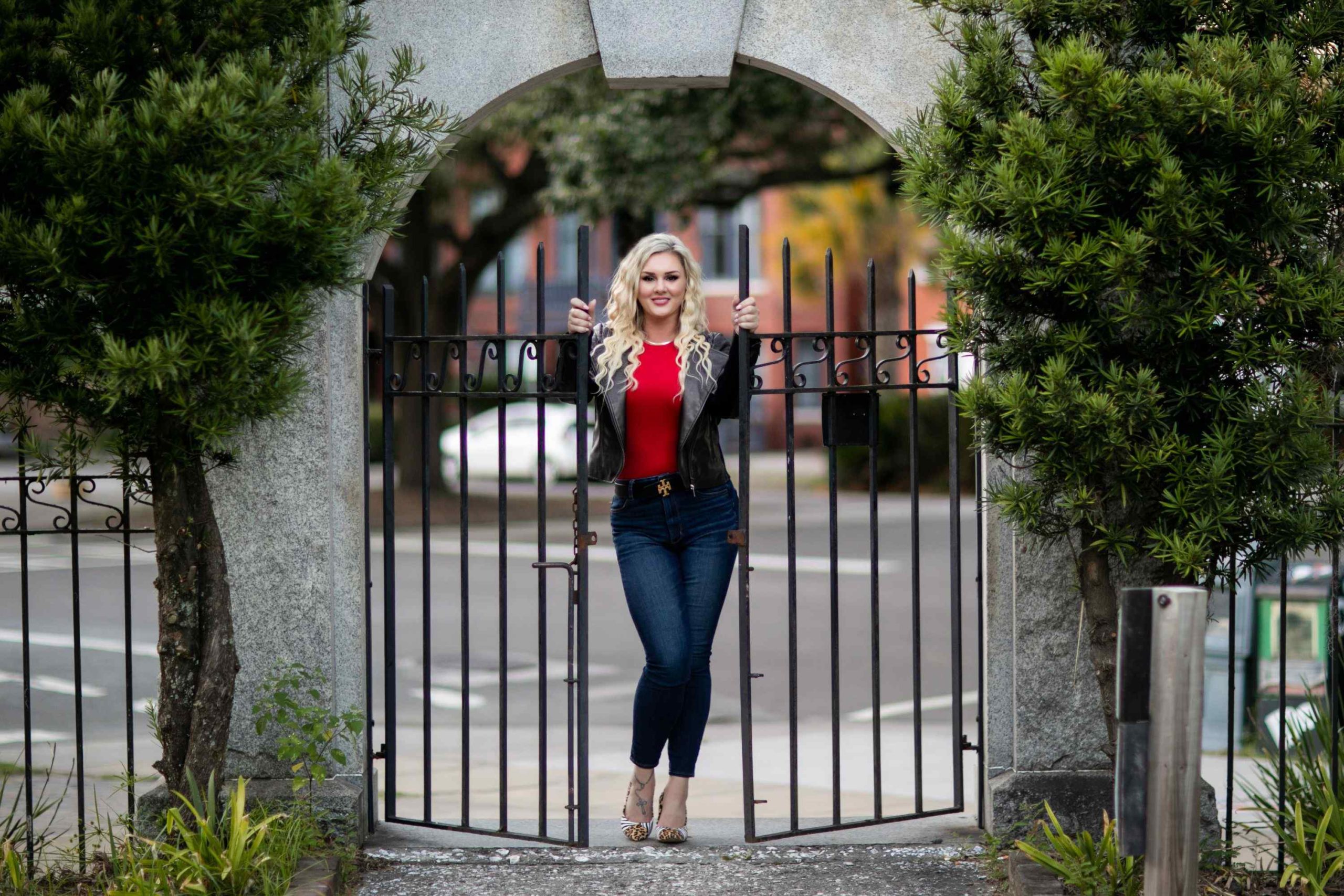 woman posing between open gates outside