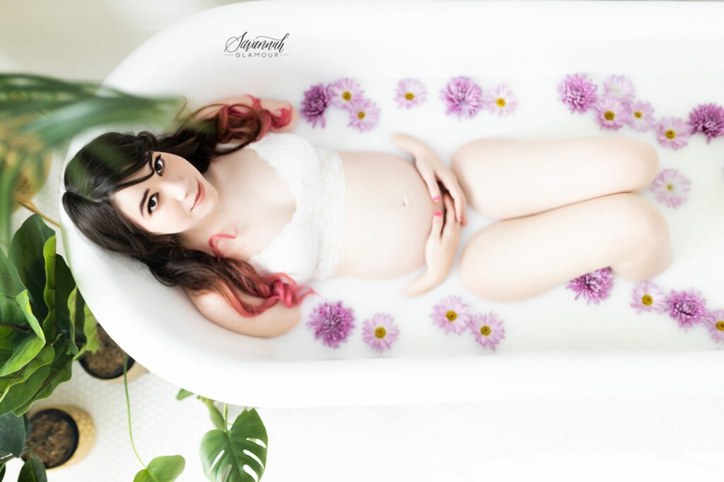 pregnant woman in a tub of milk and flowers