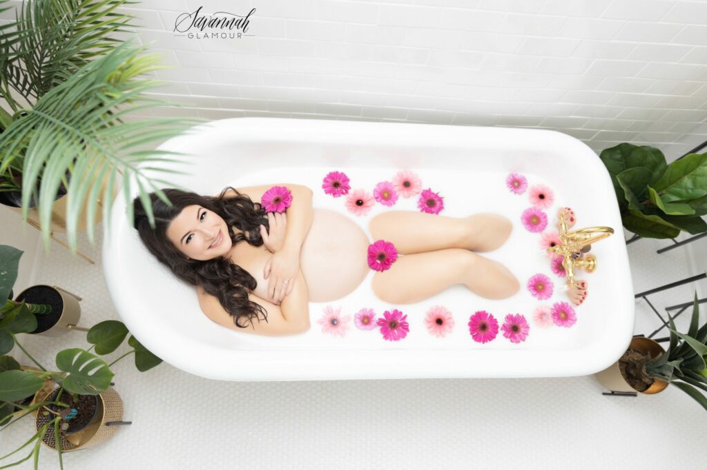 pregnant woman in a tub of milk and flowers