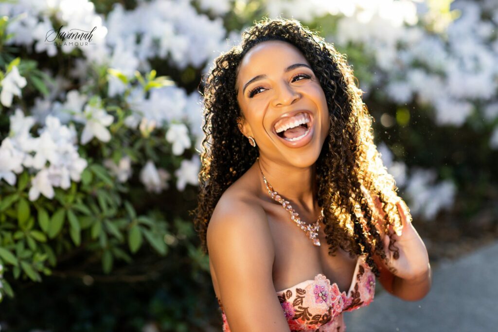 woman laughing in front of a flower bush in Savannah, Georgia