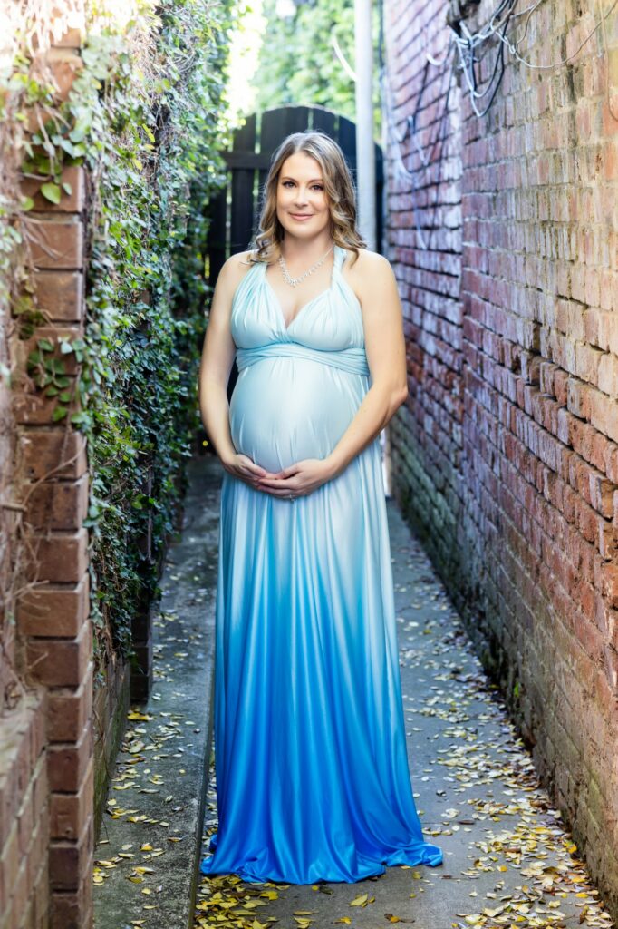 a pregnant woman in a blue gown